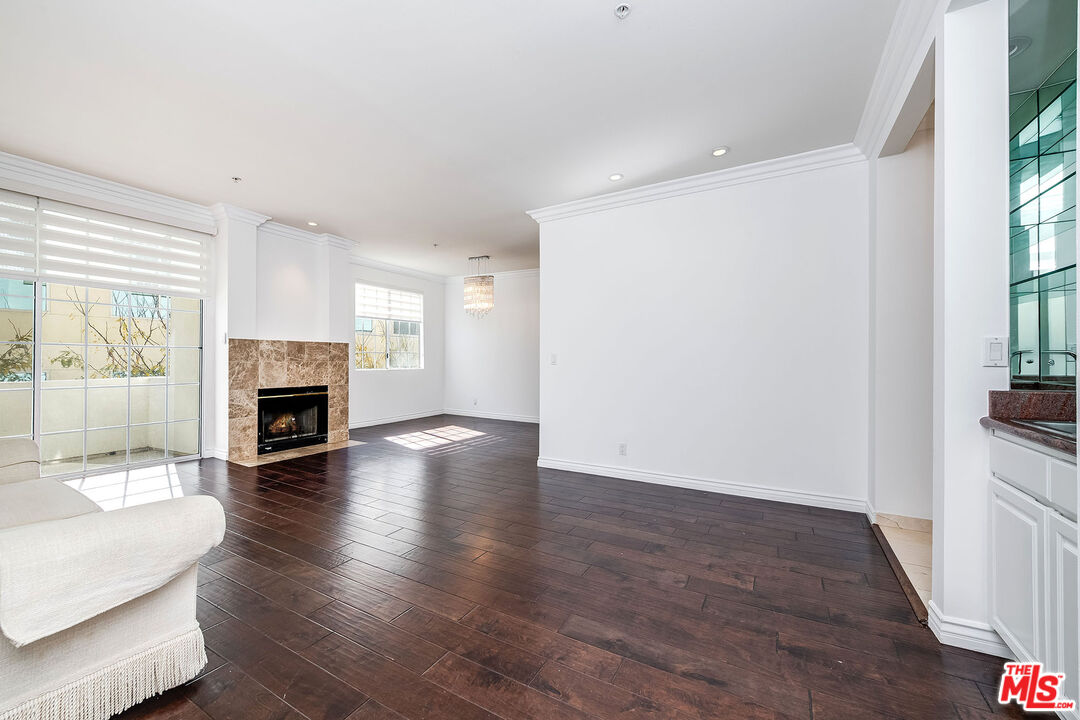 10630 Eastborne Avenue, Unit 203 Los Angeles, CA 90024 - Photo 6 of 26 a view of a livingroom with wooden floor and a fireplace