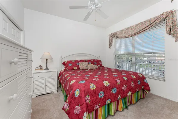 a bedroom with a large bed and a dresser
