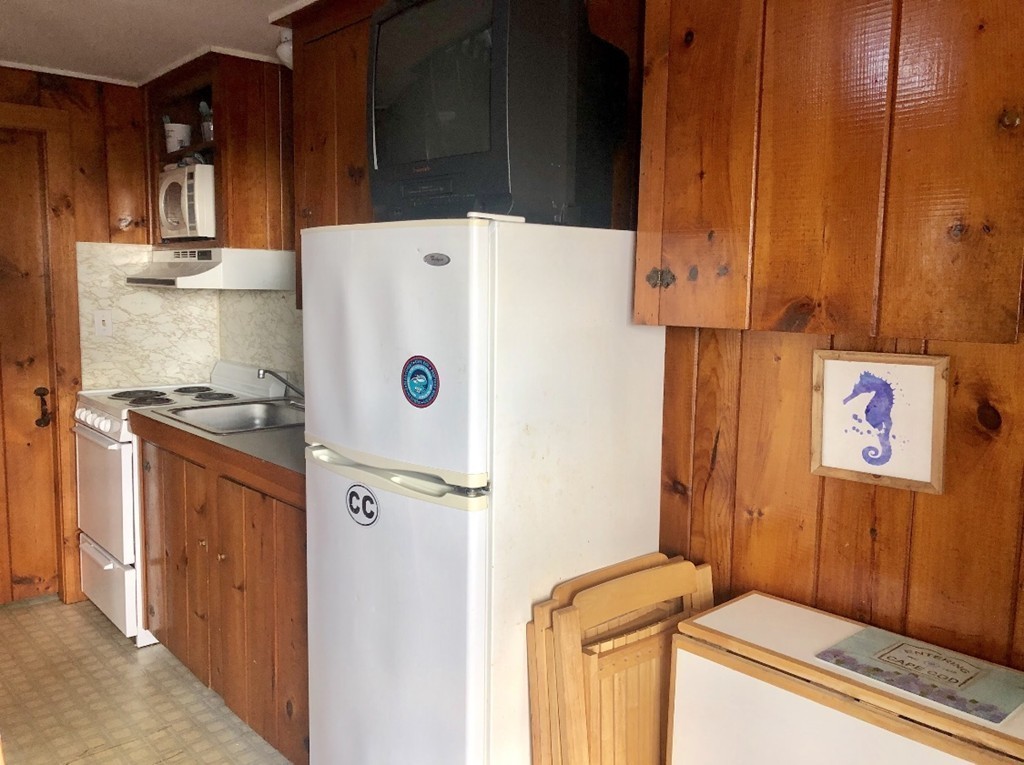 110 Glendon Road, Unit 9 Dennis, MA 02639 - Photo 9 of 22 a white refrigerator freezer sitting inside of a kitchen