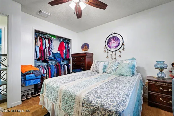 a bedroom with a bed and a chandelier