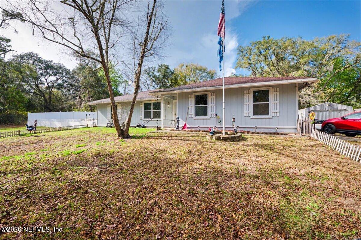 53 Lion Street Middleburg, FL 32068 - Photo 20 of 28 a front view of house with yard and trees in the background