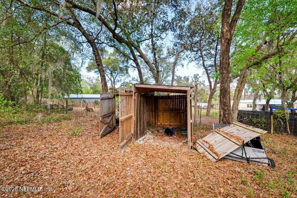 a backyard of a house with table and chairs