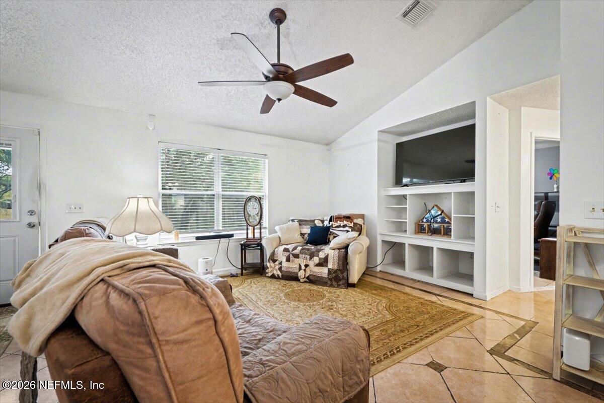 53 Lion Street Middleburg, FL 32068 - Photo 4 of 28 a bed room with a bed and a television