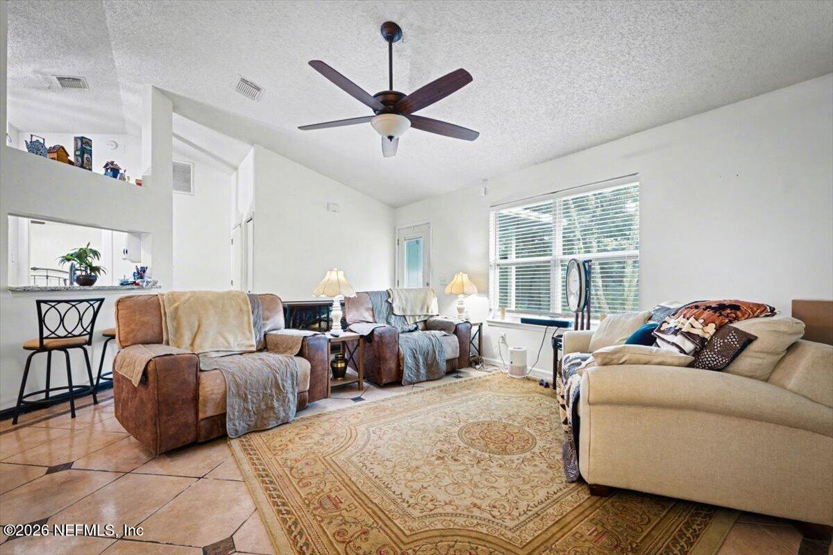 53 Lion Street Middleburg, FL 32068 - Photo 5 of 28 a living room with furniture and a large window