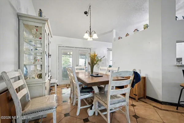 a view of a dining room with furniture and chandelier