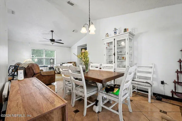 a view of a dining room with furniture and chandelier