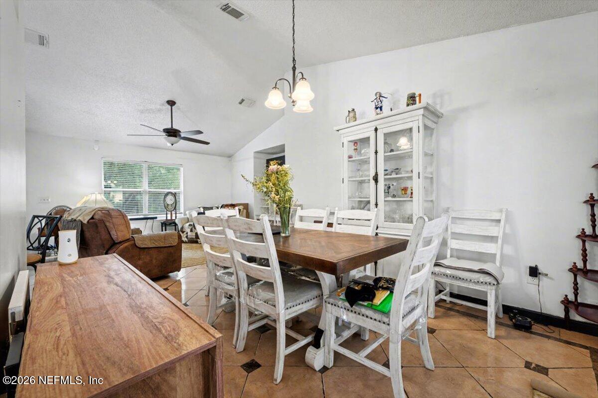 53 Lion Street Middleburg, FL 32068 - Photo 8 of 28 a view of a dining room with furniture and chandelier