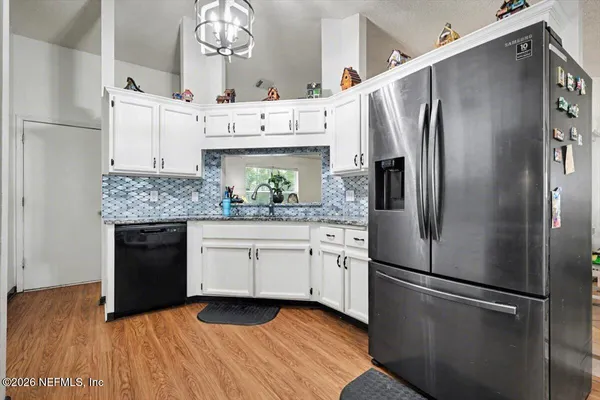 a kitchen with stainless steel appliances a refrigerator sink and cabinets