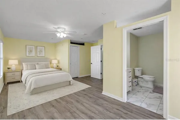 a spacious bedroom with a bed and a view of bathroom