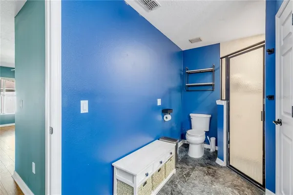 a bathroom with a toilet and a shower
