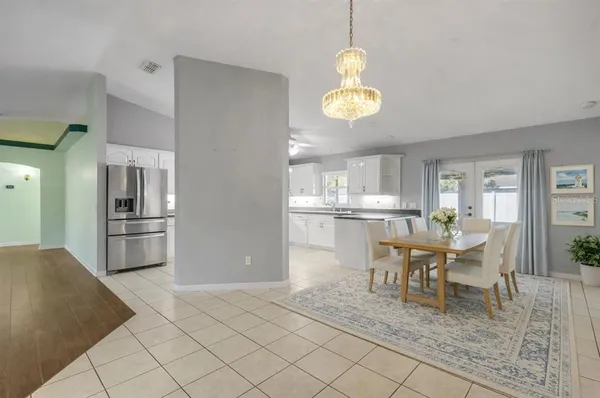 a view of a dining room with furniture and chandelier