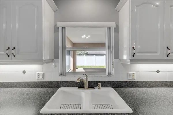 a kitchen with a sink and cabinets