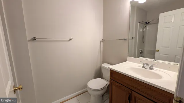 a bathroom with a sink toilet and a mirror
