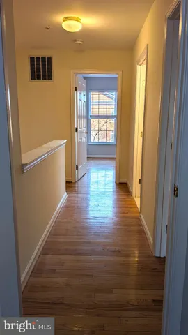 a view of an entryway with wooden floor