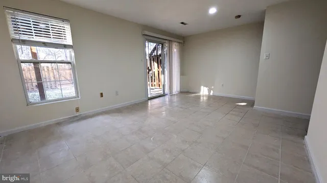 an empty room with windows and closet