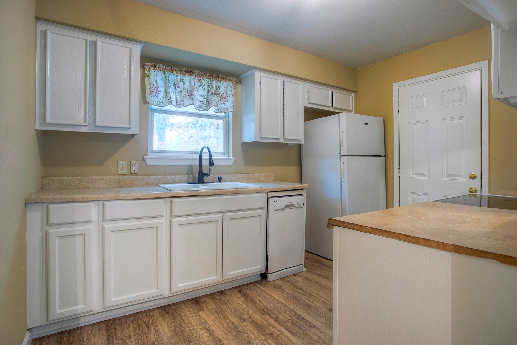 81 Westlake Road Trinity, TX 75862 - Photo 6 of 23 a kitchen with a refrigerator sink and cabinets