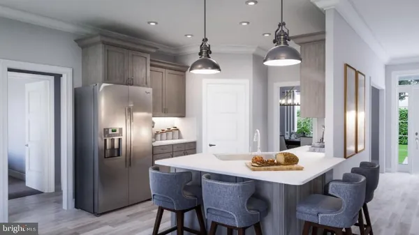 a kitchen with stainless steel appliances a dining table chairs and refrigerator