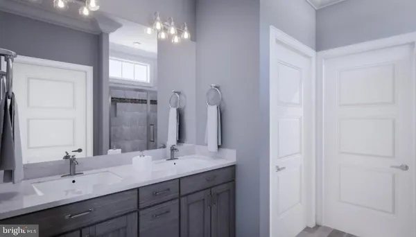 a bathroom with double vanity sinks and a mirror