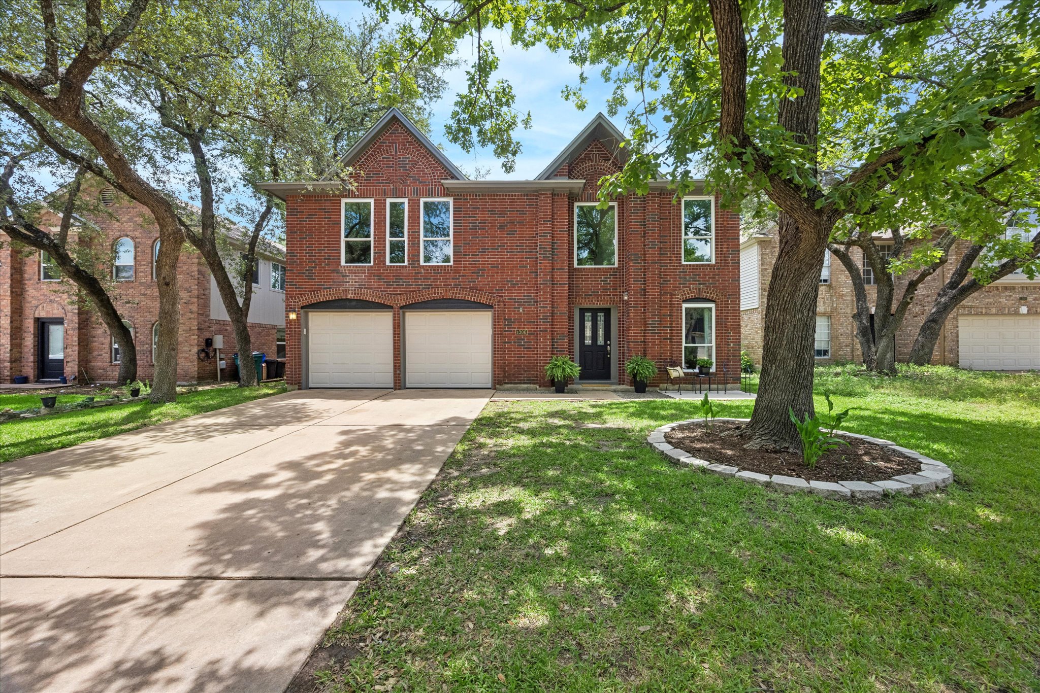 1306 Shady Grove Path Cedar Park, TX 78613 - Photo 1 of 40 a front view of a house with a yard and garage