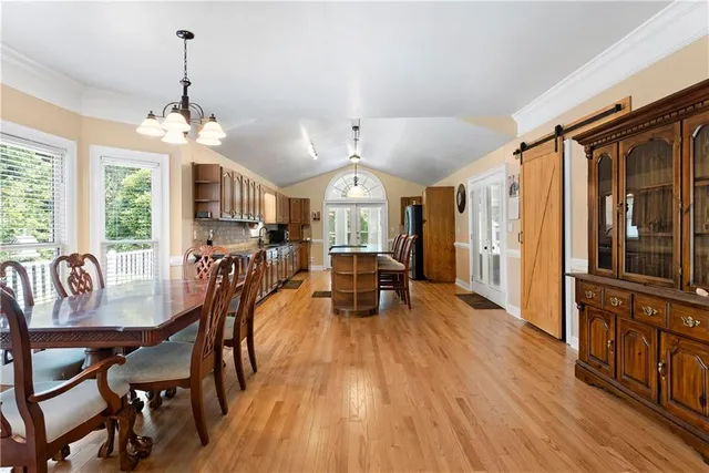 a view of a dining room with furniture window and wooden floor