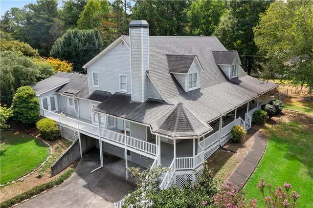 an aerial view of a house with a yard and balcony