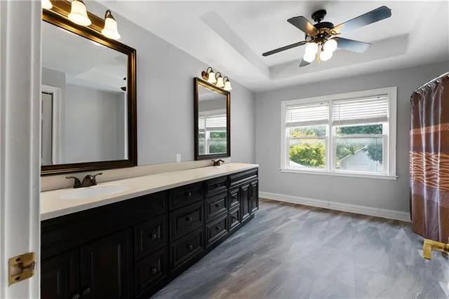 a bathroom with a double vanity sink a toilet and a window