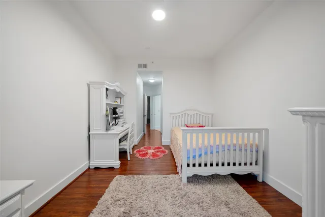 a bathroom with a granite countertop sink mirror vanity and toilet