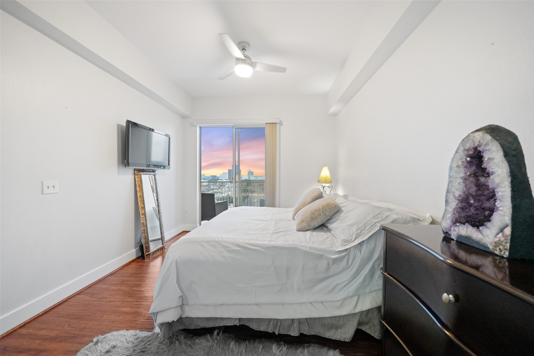 3505 Sage Road, Unit 1705 Houston, TX 77056 - Photo 19 of 38 a bedroom with a bed and wooden floor