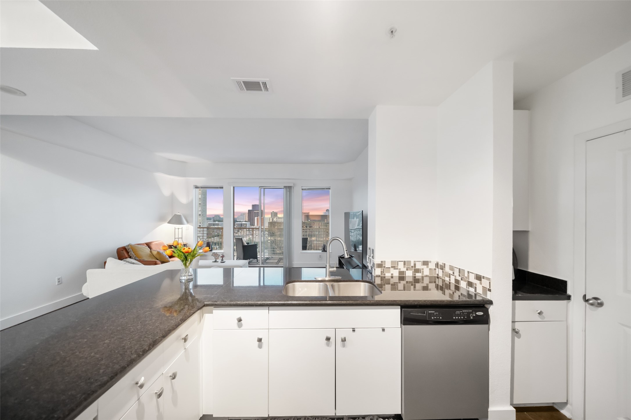 3505 Sage Road, Unit 1705 Houston, TX 77056 - Photo 27 of 38 a kitchen with granite countertop a sink and cabinets