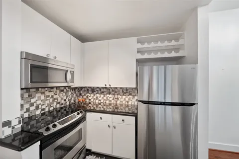 a living room with furniture and view of kitchen