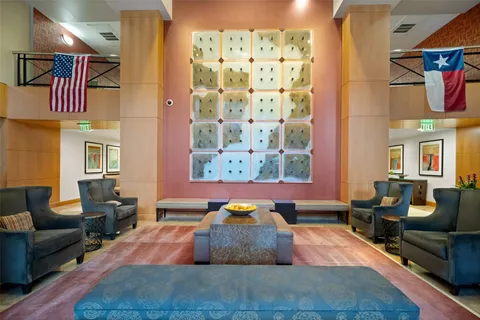 a living room with furniture a fireplace and a floor to ceiling window