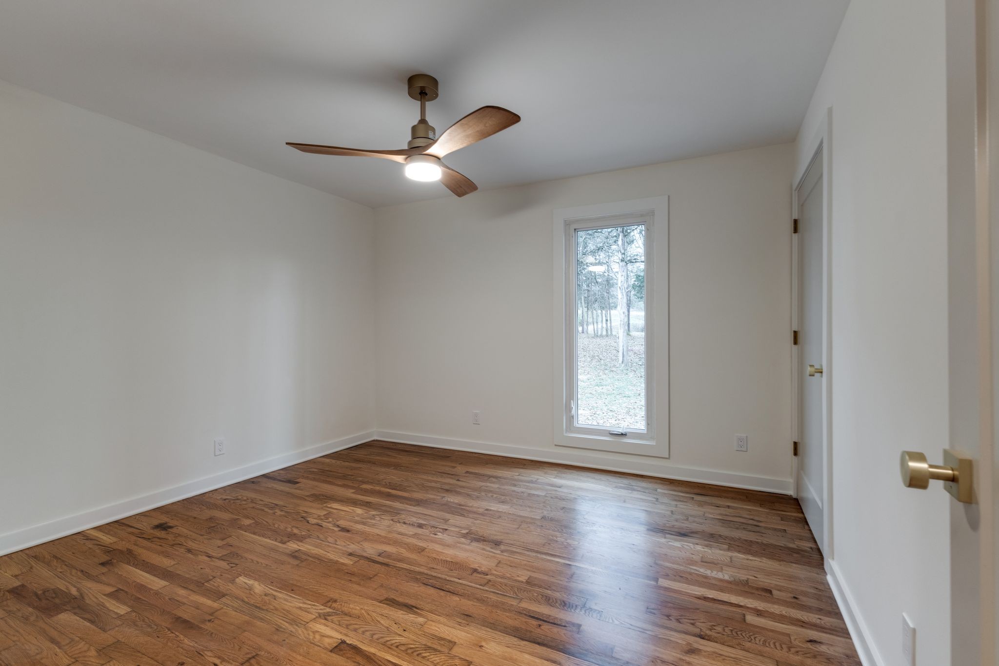4342 Murfreesboro Road Franklin, TN 37067 - Photo 22 of 41 a view of empty room with wooden floor and fan