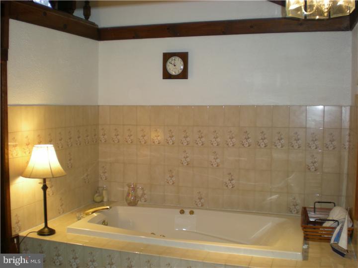 17 Center Road Pemberton, NJ 08068 - Photo 15 of 22 a bathroom with a tub and shower