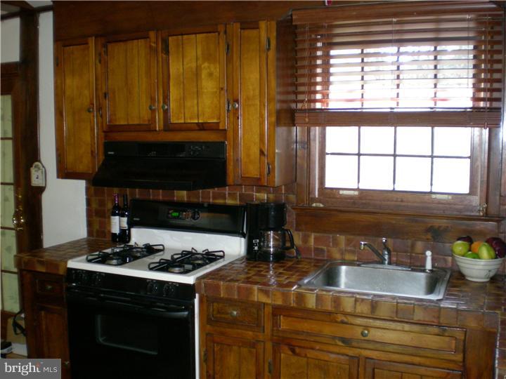 17 Center Road Pemberton, NJ 08068 - Photo 6 of 22 a kitchen with granite countertop a stove a sink and a cabinets