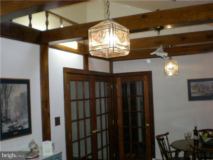 17 Center Road Pemberton, NJ 08068 - Photo 8 of 22 a view of a hallway with a chandelier