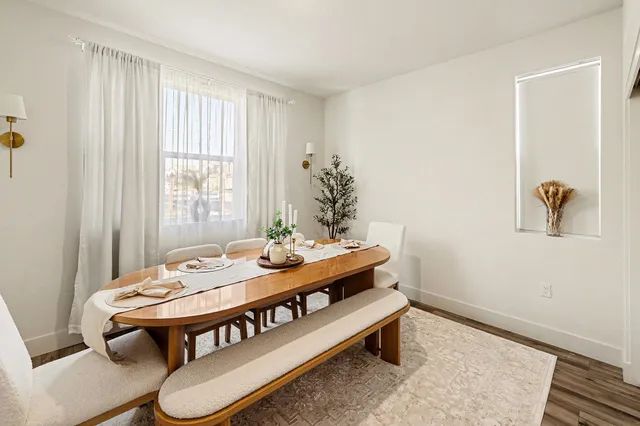 a view of a dining room with furniture and window
