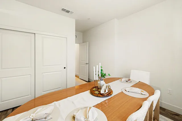 a dining room with furniture and wooden floor