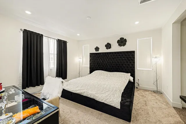 a bed sitting in a bedroom next to a window