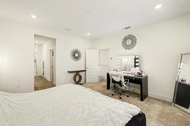 a bedroom with a bed and a table in it