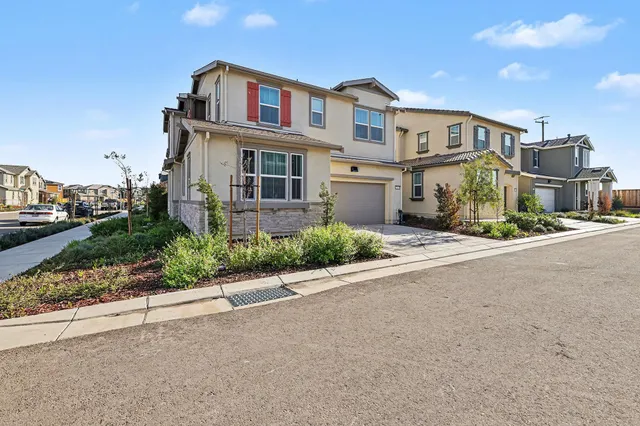 a front view of a residential apartment building with a yard