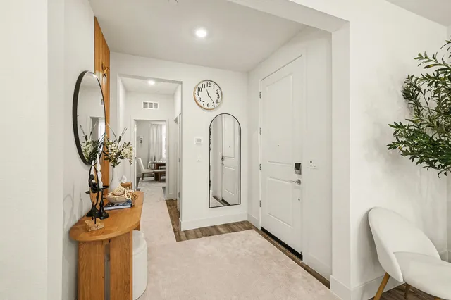a view of an entryway with wooden floor