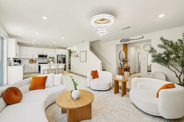 a living room with furniture and kitchen view