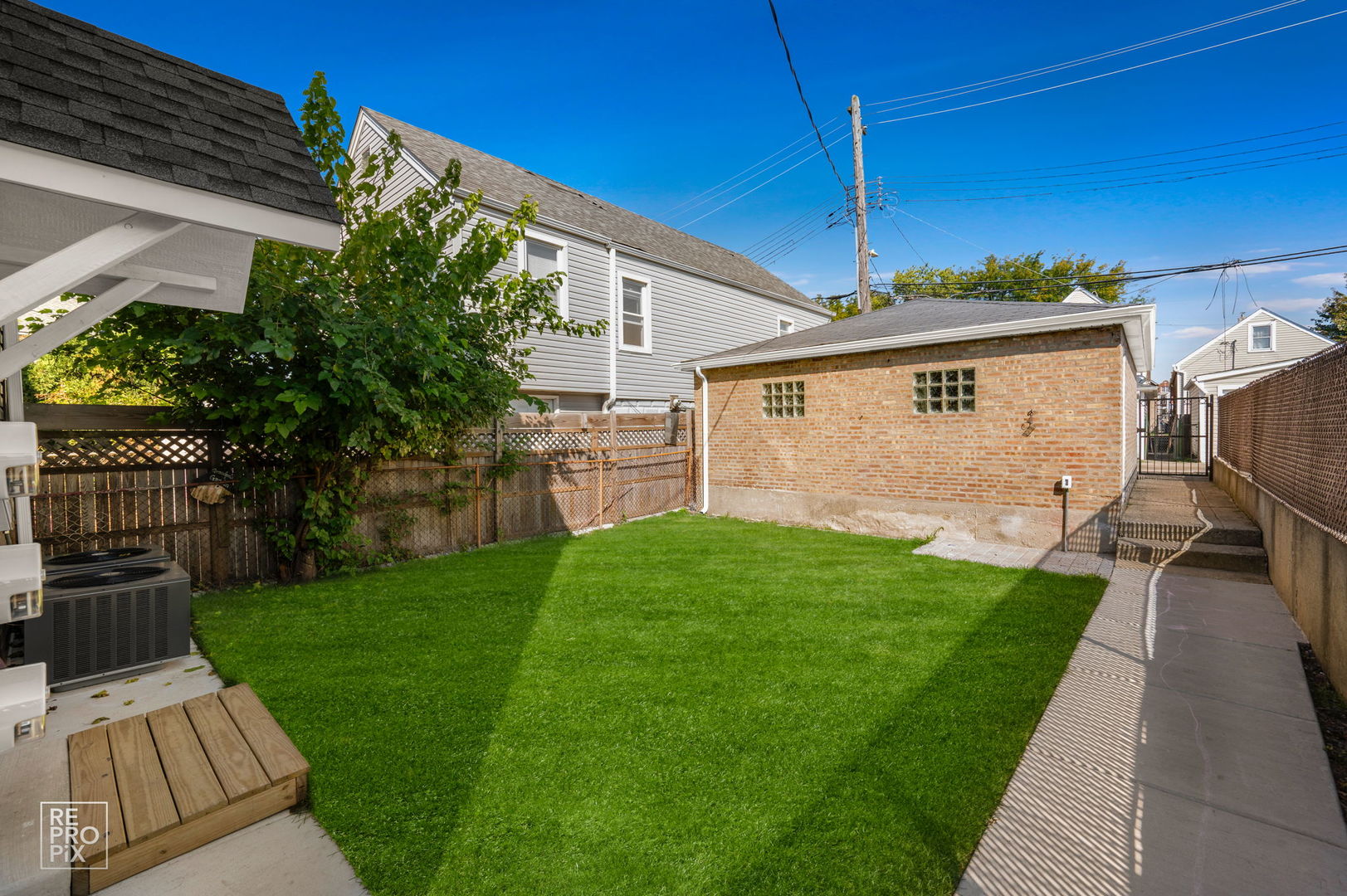 1624 West Pershing Road Chicago, IL 60609 - Photo 21 of 28 a view of a backyard with plants and a patio