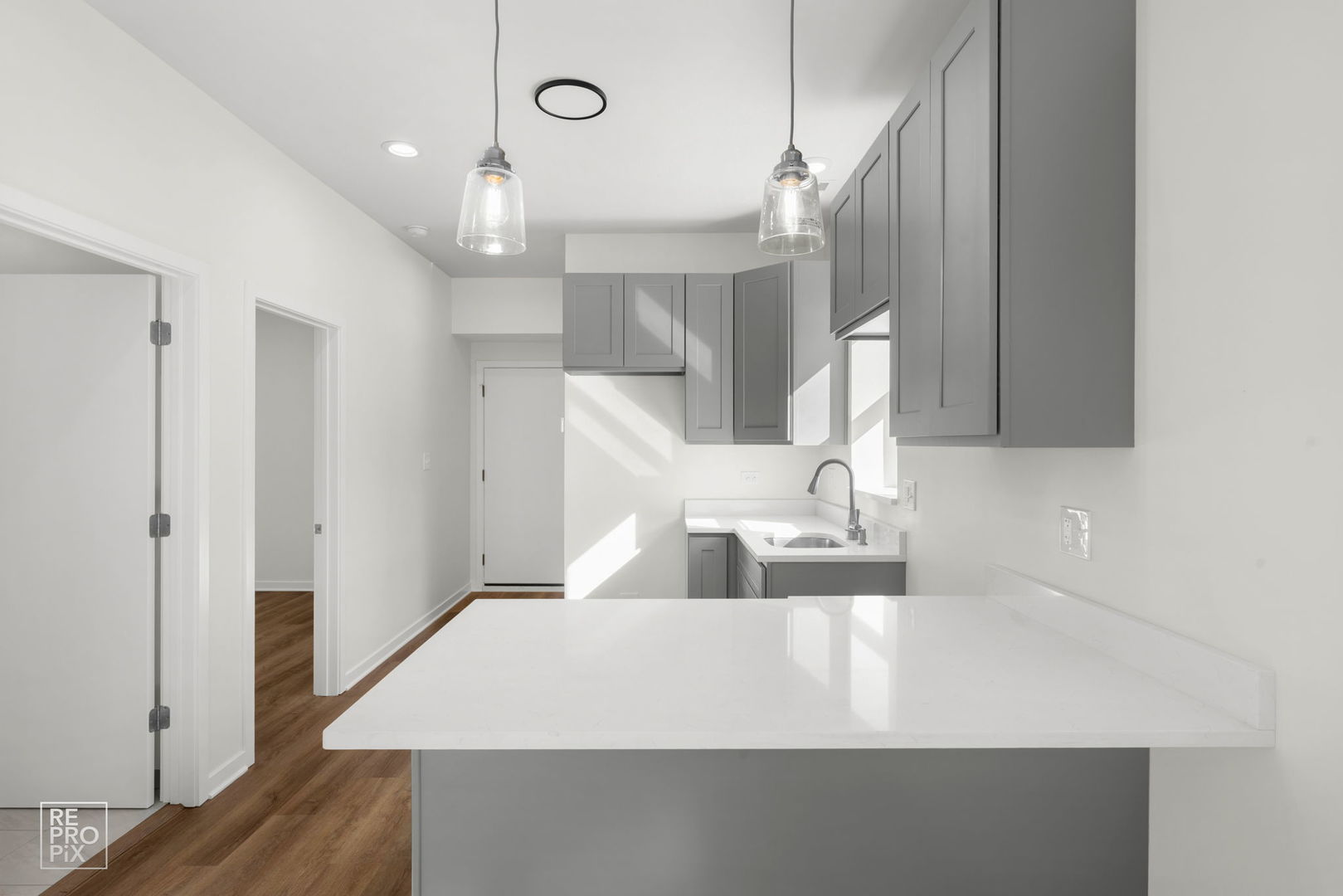 1624 West Pershing Road Chicago, IL 60609 - Photo 4 of 28 a large white kitchen with wooden floor