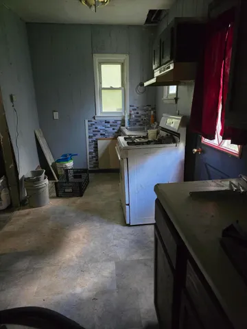 a kitchen with a sink a stove and a refrigerator