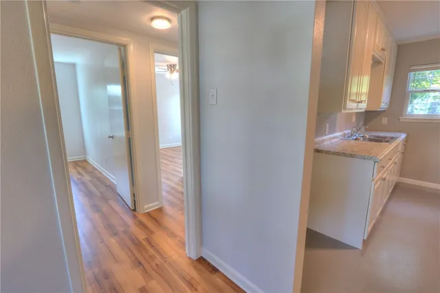 a bathroom with a sink and mirror with toilet