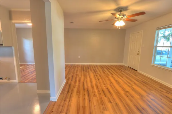 wooden floor in an empty room with a window