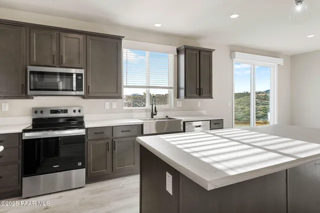 a kitchen with a stove a sink and a microwave