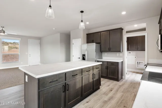 a large kitchen with a large counter top appliances and cabinets
