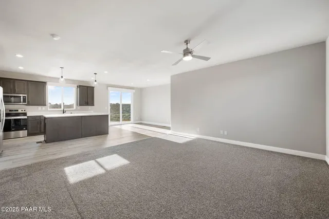 a view of a kitchen with a sink and a window